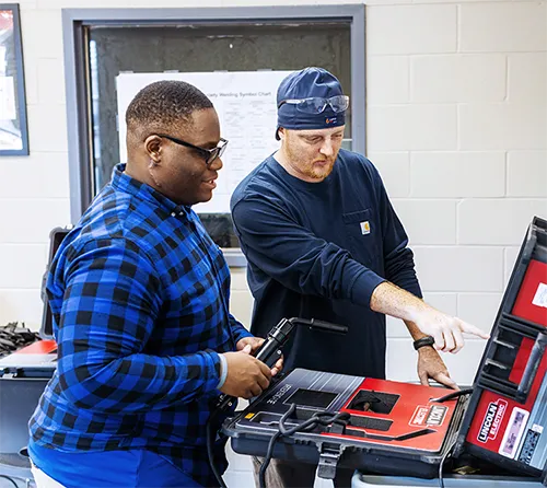Two students working with tools